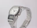 Right side view of Casio AW-61 watch on stand, showing the 'light' button and crown details.