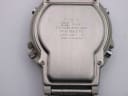 Close-up of the brushed stainless steel case back of the Casio AW-61, showing model number and manufacturing information.