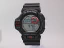 Front view of the Casio G-Shock GDF-100 watch, black case and strap, showing grey digital display with red accents.