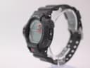 Right-side view of the Casio G-Shock GDF-100 watch on a stand, showing the mode buttons and black resin strap.