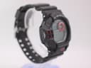 Left-side view of the Casio G-Shock GDF-100 watch on a stand, showing the sensor panel and adjust buttons.
