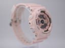 Left-side profile view of the pink G-SHOCK watch showing "MODE" and "ADJUST" buttons.
