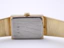 Close-up of the watch case back, a brushed metal surface with '1991' engraved.