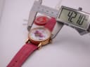A digital caliper measuring the case diameter of the Constantin Weisz watch, with the display showing an exact measurement of 42.10 mm, held against the pink leather strap.