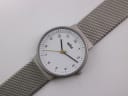 Top-down angled view of the Braun BN0031WHSLMHL watch, displaying the white dial and the silver mesh strap laid flat.