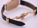 Close-up of the brown leather strap with a rose gold PVD deployant clasp, signed 'Tissot'.