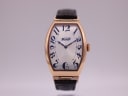 Front view of the Tissot T128509 A watch, showing the cream dial with blue Arabic numerals and rose gold tonneau case.