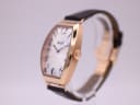 Angled side view of the Tissot T128509 A watch, highlighting the polished rose gold PVD tonneau case and signed crown.