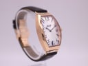 Opposite angled side view of the Tissot T128509 A watch, showing the elegant curve of the tonneau case.