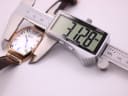 Digital caliper measuring the case width of the Tissot watch at 31.28mm.