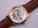 Close-up, top-down view of the PWC London skeleton dial, revealing the intricate gears and 'PWC LONDON' branding