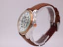 Right-side view of the Rotary watch, showing the rose gold-tone crown and case profile.
