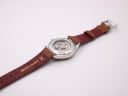 Back view of the watch, showing the case back and extended genuine leather strap with "20" lug width marking.