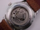 Close-up of the display case back, showing the Miyota automatic movement, model number, serial, and "mineral glass" inscription.