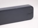 Close-up of a damaged dark grey plastic watch box, generic and not original.