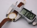Digital caliper measuring the watch case, displaying 31.02mm.