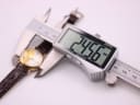 Digital caliper measuring the watch case diameter at 24.56mm.