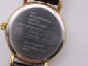 Close-up of the watch case back, engraved with 'The Warner Bros. Watch Collection' and serial number WB17210075.