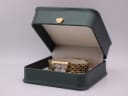 Raymond Weil Tango watch nestled in a generic green display box with a small gold crown emblem.