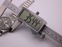 Digital caliper measuring the case diameter of the Seiko watch at 35.44mm.