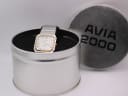 The AVIA Flatline watch presented in its original AVIA 2000 tin box, with the lid next to it.