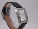 Side profile of the Giorgio Armani square watch case with curved lugs.