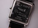 Close-up of the case back engraving, showing serial number 0453/1200, 'Hope' character, and 'Whatever It Takes.org'.