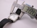 Digital caliper measuring the watch case, showing a precise width of 34.94mm.