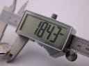 Digital caliper display showing the watch case diameter measurement of 18.43mm.