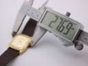 Side view of the Lorus watch case being measured by a digital caliper, displaying a precise measurement of '27.69 mm' for the case size.