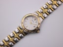 Top-down view of the Bulova two-tone watch and its integrated steel bracelet.