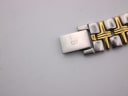 Close-up of the two-tone bracelet's fold-over clasp, clearly showing the 'B' Bulova logo.