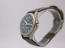 Side view of Lorus titanium watch, crown visible, on display stand.