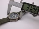 Digital caliper measuring the case diameter of the Lorus watch, showing 37.24mm on the display.