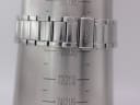 Close-up of the signed Seiko fold-over clasp on a wrist sizing gauge, showing a wrist circumference reading of approximately 20.8cm.