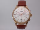 Front view of Henry London Pimlico watch with rose gold case, white dial, and brown leather strap on a watch stand.