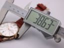 Digital caliper measuring the case diameter of the Henry London watch, displaying a precise measurement of 38.63mm.