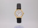 Front view of Tissot T825/925 ladies' watch on a display stand, showing the gold case, white Roman numeral dial, and black leather strap.