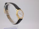 Another angled side view of the gold Tissot watch on a display stand, showing the crown and the strap.