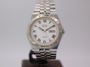 Front view of the Seiko SQ 100 two-tone watch with white dial and black Roman numerals.