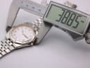 Digital caliper measuring the Seiko SQ 100 case diameter, showing 38.85mm on the display.