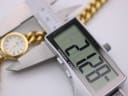 Digital caliper measuring the watch case diameter, showing a reading of 22.28mm.