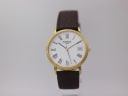 Front view of Tissot T870/970 gold-plated watch with white dial, Roman numerals, and brown leather strap.