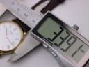 Digital caliper measuring the watch case, displaying a precise diameter of 33.91mm.