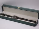 The Michel Jordi watch presented inside a generic green leatherette display box.
