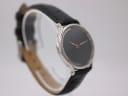 Another angled view of the Michel Jordi watch, highlighting the dial and case profile.