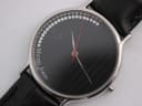 Close-up of the black dial with crystal hour markers, red seconds hand, and "Michel Jordi Swiss Made" logo.