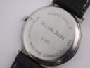 Detailed close-up of the watch case back engravings for Michel Jordi G 900.