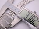 Digital caliper measuring the Seiko watch case, displaying a precise diameter of 31.82mm.