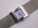 Close-up, angled view of the Tissot L610K dial, showing the 'TISSOT 1853' logo, 'SWISS MADE' text, and vertical dial texture.